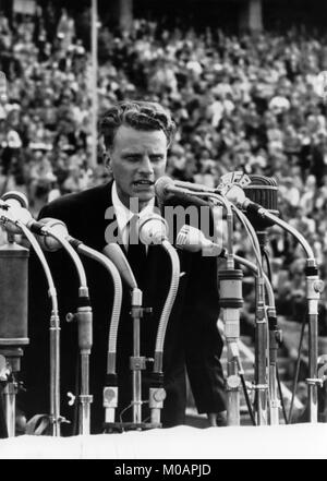 American evangelist Billy Graham addressing a crowd of over 100,000 at the Olympic Stadium in Berlin, Germany in June, 1954. Stock Photo