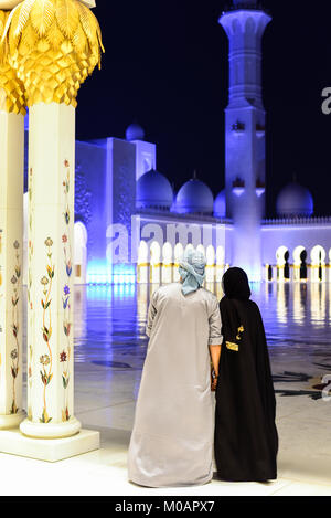 ABU DHABI, UAE - OCTOBER 24, 2017: Arabic muslim couple at Sheikh Zayed Grand Mosque Stock Photo