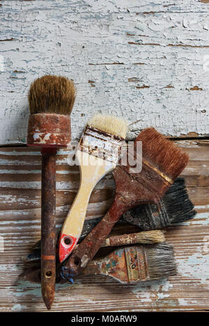 Set of used brushes on a wooden surface with, retro and vintage objects, text place Stock Photo