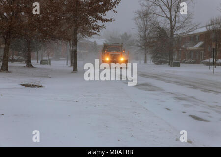 Snowplow removing snow from city road Tractor Snow clearing Stock Photo