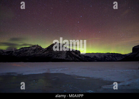 Northern lights over Lake Minnewanka, Alberta, Canada Stock Photo