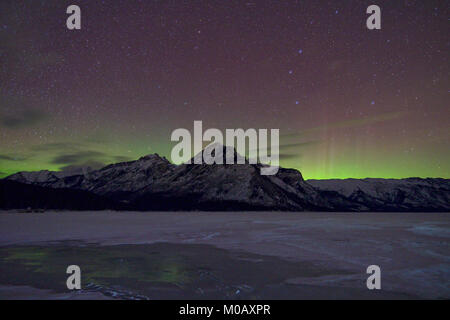 Northern lights over Lake Minnewanka, Alberta, Canada Stock Photo