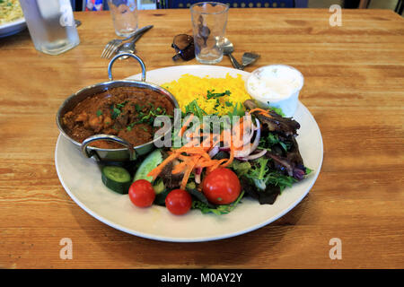 Saffron rice with chicken curry and fresh salad and yogurt Stock Photo
