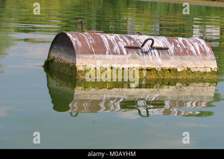 Industrial barrel thrown into the lake for garbage and make a big pollution. Water pollution. Climate changes. Industry pollution. Waste, garbage Stock Photo