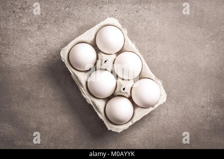 Six eggs in paper container box. Stock Photo