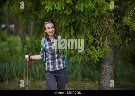 young woman with nordic walk pols Stock Photo