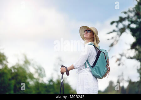 young woman with nordic walk pols Stock Photo