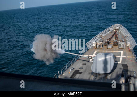 The guided-missile cruiser USS Monterey (CG 61) fires its  5-inch 54-caliber gun. Stock Photo