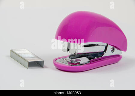 Small Pink Stapler with staples on a white background Stock Photo