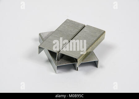 Stack of metal staples on a white background Stock Photo
