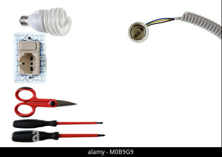 Scissors, screwdrivers, light bulb, switch, socket, lamp holder, electric cable and sheath for a residential electrical installation, photographed on  Stock Photo