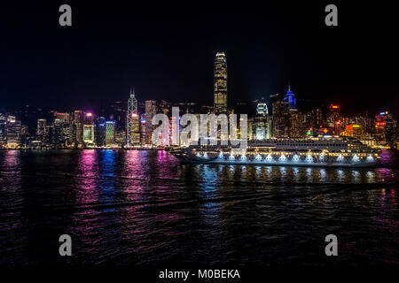 Tsim Sha Tsui, Hong Kong  - January 17, 2018 : Star Pisces leaves Ocean Terminal passing Victoria Harbor at night Stock Photo
