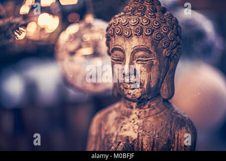 Vintage style photo of the wooden statue of Buddha, God of oriental religion, conceptual picture of meditation, mindfulness and inner peace Stock Photo