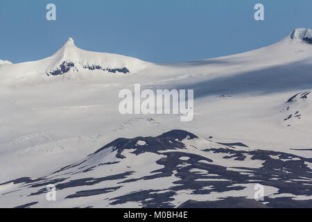 The mystical Snæfellsjokull Glacier meets the sky at the tip of Snæfellsnes Peninsula, rising above other mountains to the height of 1446 meters. Icel Stock Photo