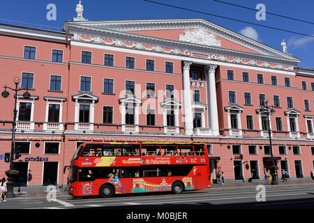 Double-decker sightseeing tour bus against the Literary house on Nevsky avenue. Stock Photo