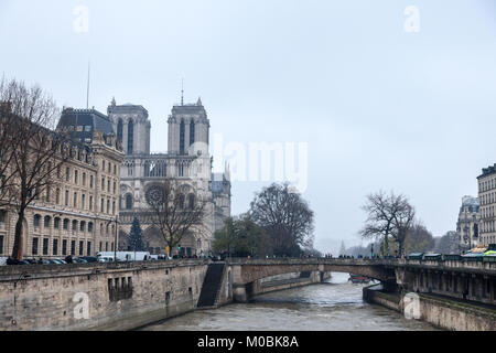 PARIS, FRANCE - DECEMBER 20, 2017:  Notre Dame de Paris Cathedral taken from the Seine river with the Double bridge (pont du Double) in front during a Stock Photo