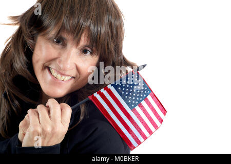 Attractive Middle aged woman with brown layered hair smiling while holding an American Flag over her shoulder isolated on white Stock Photo