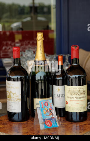 Bordeaux, France - June 27, 2013: Large wine bottles in the show window of a restaurant. Bordeaux region is one of the leading French producers of win Stock Photo
