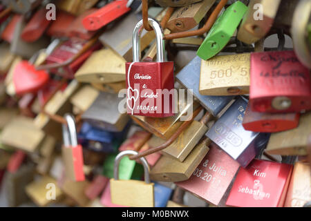 Cologne, Germany - June 30, 2013: Love padlocks on the fence of Hohenzollern bridge. Since 2008 people have placed love locks on the fence between the Stock Photo