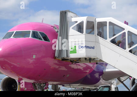 Dortmund, Germany - June 22, 2013: Passengers leave the Wizzair plane in the airport of Dortmund, Germany on June 22, 2013. Created in 2004, now Wizza Stock Photo