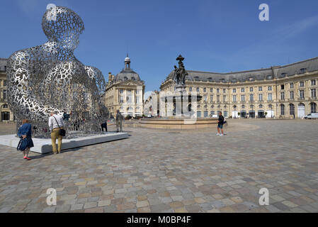 Bordeaux, France - June 27, 2013: Tourists in front of the artwork of Jaume Plensa House Of Knowledge against the Fountain of Three Grace on the Place Stock Photo