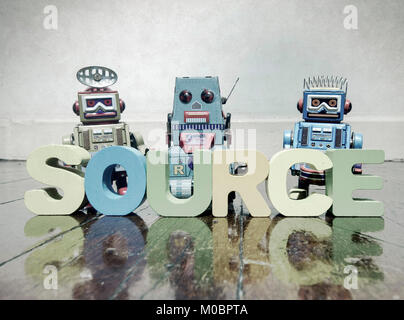 team of robots and the word source on a old wooden floor Stock Photo