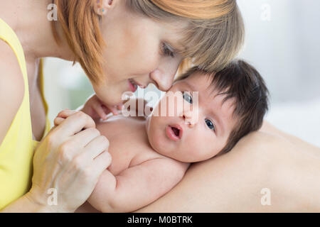 Portrait of happy mother and newborn baby