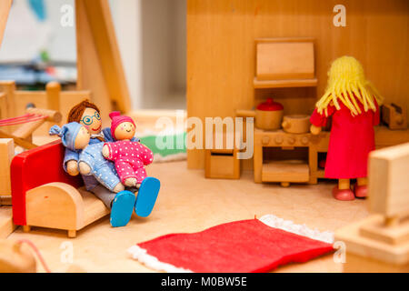 Closeup of wooden dollhouse family enjoying their time together Stock Photo