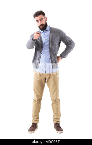 Young bearded stylish teacher or business man pointing finger at camera. Full body length portrait isolated on white studio background. Stock Photo