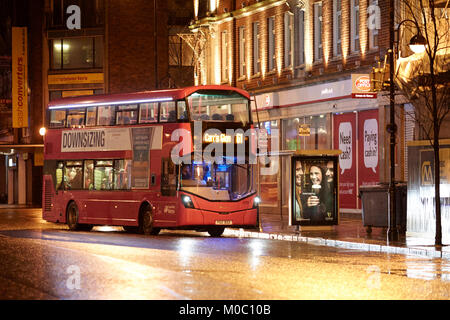translink metro double decker bus on wet empty street in belfast city centre northern ireland uk Stock Photo