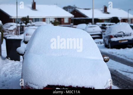 car parked on the street windscreen covered in snow in newtownabbey northern ireland Stock Photo
