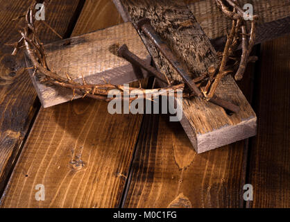 Crown of thorns and wood cross on a wooden surface Stock Photo