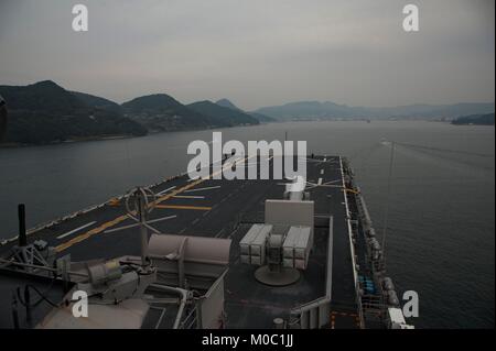 The amphibious assault ship USS Wasp (LHD 1) prepares to arrive in Sasebo, Japan. Wasp is relieving the USS Bonhomme Richard (LHD 6) as the forward-deployed flagship of the amphibious forces in the U.S. Navy. Stock Photo