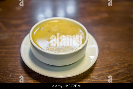 Traditional Turkish hot Tripe Soup served on wooden table. Stock Photo