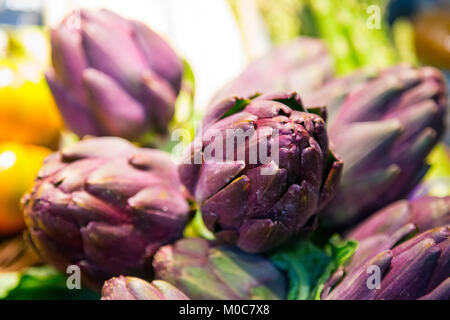 Purple fresh artichokes on display (Östermalms Saluhall, Stockholm, Sweden) Stock Photo