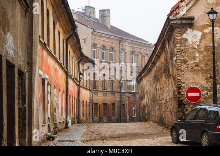 Dilapidated, run-down side street of empty old terraced houses with crumbling brickwork in Vilnius Old Town, capital city of Lithuania, eastern Europe Stock Photo