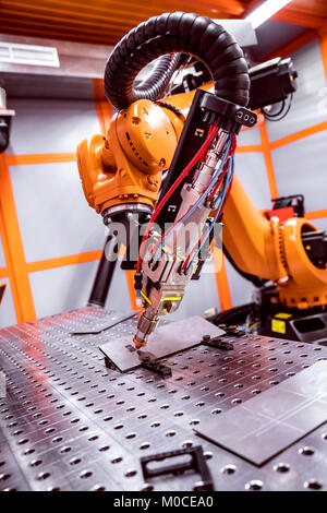 Fibre laser robotic remote cutting system. CNC Laser plasma cutting of metal, modern industrial technology. Stock Photo