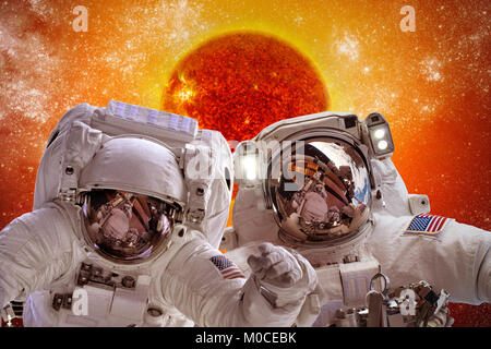 Spacecraft and astronauts in space on background sun star. Elements of this image furnished by NASA. Stock Photo