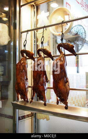 row of roast ducks displayed in the shop for sale Stock Photo
