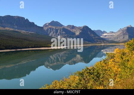 A calm clear day with a wonderful reflection of the mountains in the water, at Many Glaciers, Montana, USA Stock Photo