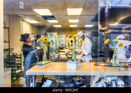 New York City, USA - October 27, 2017: Cooking class school through window in Culinary Tech Center LLC, NYC in Chelsea West Side, with people chefs tr Stock Photo