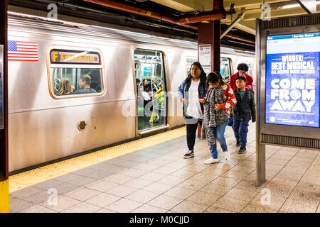 New York City, USA - October 27, 2017: People in underground platform transit in NYC Subway Station after work on commute with train Stock Photo