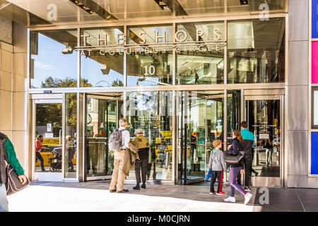 New York City, USA - October 28, 2017: Columbus Circle in Midtown Manhattan NYC, with entrance to shopping mall called Shops, doors, people entering b Stock Photo