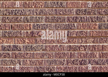 Textured brown brick wall background with unique stone pattern in shades of brown red and pink Stock Photo