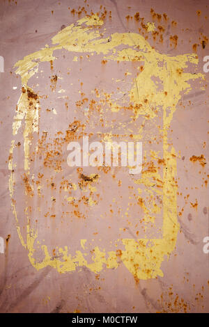 Peeling brown and yellow paint on a rusty metal texture Stock Photo