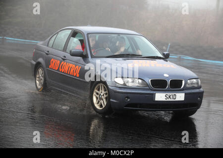 A young driver is given instruction on how to control a car during course at the skid pan centre at knockhill racing circuit in fife, scotland Stock Photo