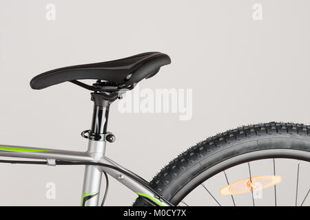 Bike saddle and part of rear wheel on white background, close up view, studio photo. Stock Photo