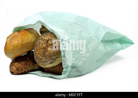 fresh German style bread rolls in paper bag isolated on white background Stock Photo