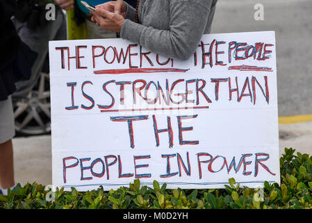 Palm Beach, Florida, USA. 20th Jan, 2018. A Trump protestor holds a protest sign near the Clock Tower on South Ocean Boulevard before the start of the ''Impeachment March to Mar-A-Largo'' on Palm Beach, FL, on Saturday, January 20, 2018. Hundreds of participants gathered in Palm Beach to march towards Mar-A-Largo and protest President Trump on the day marking the first year anniversary of his presidency. Credit: Andres Leiva/The Palm Beach Post/ZUMA Wire/Alamy Live News Stock Photo