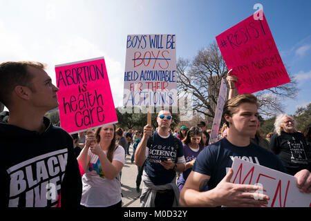 Protesters hold placards during a Trump pro-impeachment rally in Dayton ...